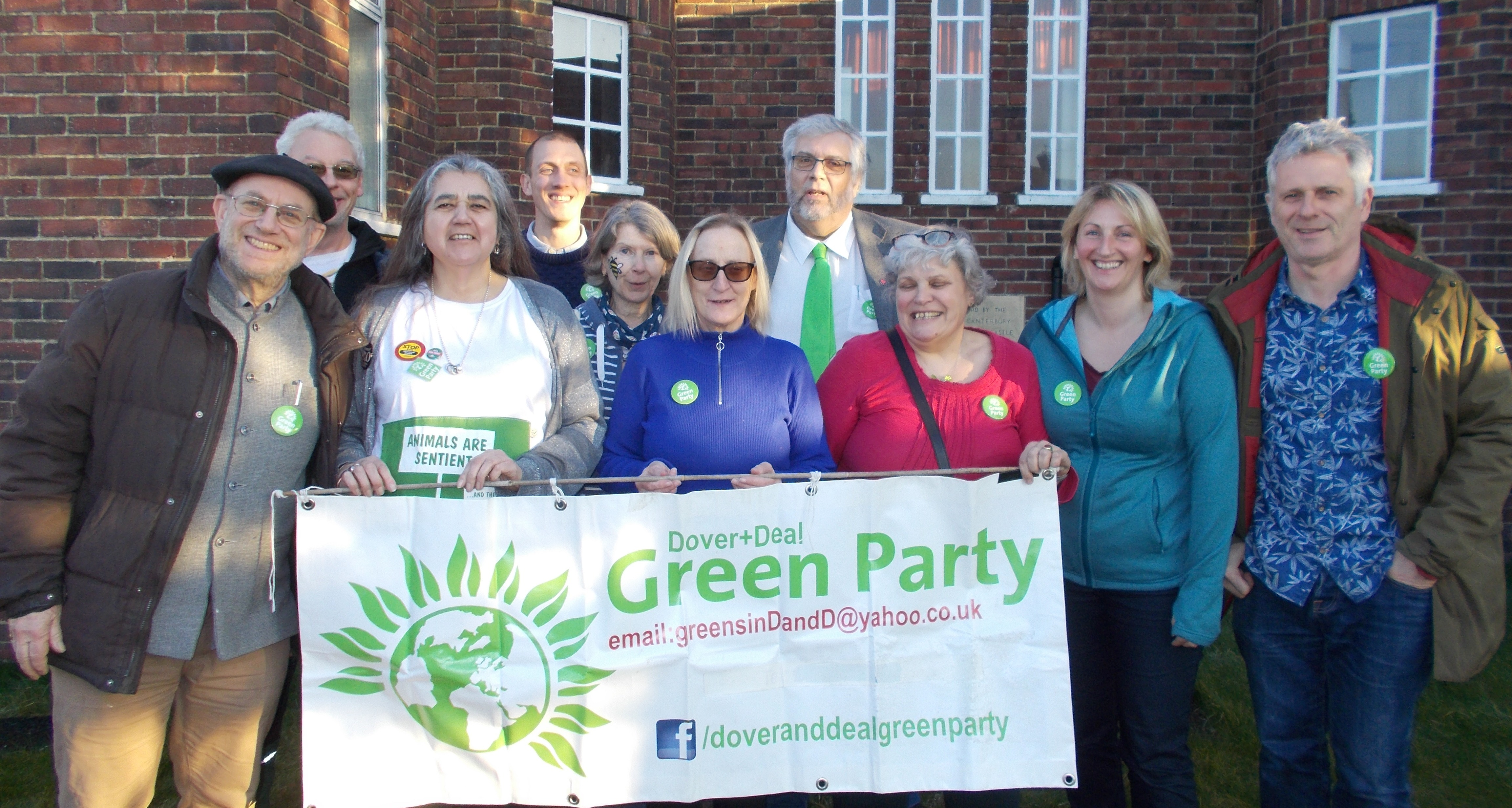 Photo of candidates: 5 women and 5 men holding campaign banner for Dover and Deal