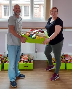 Photo: Gary and another volunteer at the Bilbrook Initiatives Hub putting together food boxes for local residents in need.